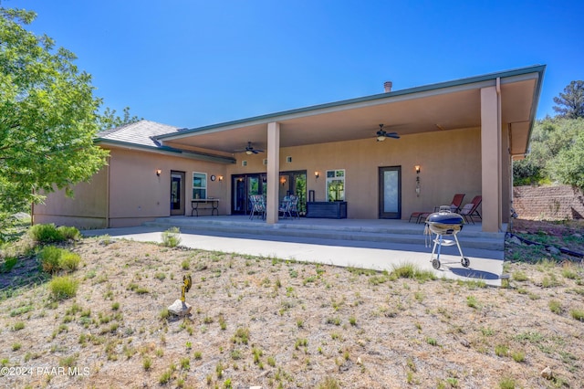 rear view of house featuring ceiling fan and a patio