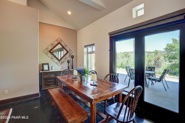 dining room featuring high vaulted ceiling