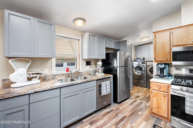 10157 Manzanita Trl, Dewey-Humboldt, AZ 86327 - kitchen with appliances with stainless steel finishes, gray cabinetry, light wood-style floors, separate washer and dryer, and a sink
