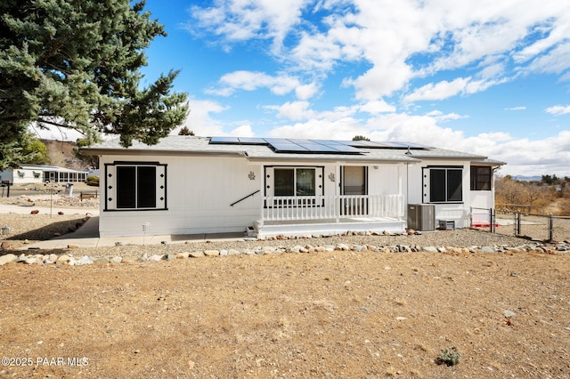 10157 Manzanita Trl, Dewey-Humboldt, AZ 86327 - view of front facade featuring central air condition unit, fence, a porch, and solar panels