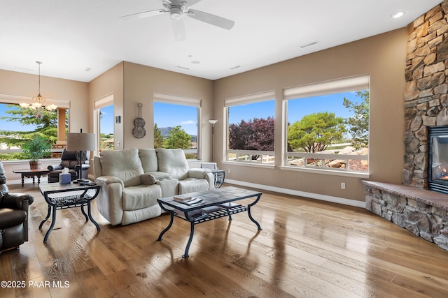2117 Colter Bay Ct, Prescott, AZ 86301 - living area featuring hardwood / wood-style flooring, baseboards, a chandelier, a ceiling fan, and a fireplace