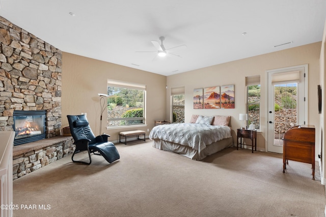 2117 Colter Bay Ct, Prescott, AZ 86301 - bedroom featuring carpet floors, access to outside, a stone fireplace, and a ceiling fan