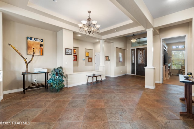 2117 Colter Bay Ct, Prescott, AZ 86301 - foyer entrance featuring ornate columns, stone tile floors, baseboards, a raised ceiling, and a chandelier