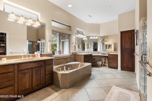 2117 Colter Bay Ct, Prescott, AZ 86301 - full bath with a bath, two vanities, a towering ceiling, and tile patterned flooring