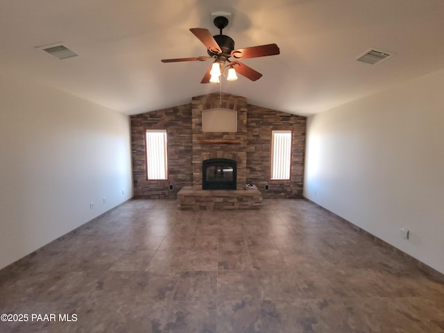 unfurnished living room featuring ceiling fan, vaulted ceiling, and a fireplace