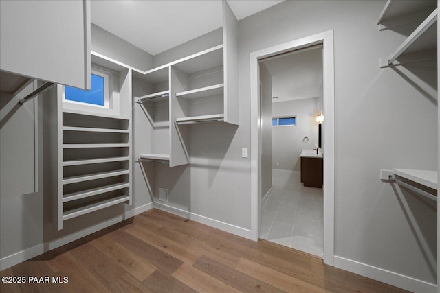 walk in closet featuring wood-type flooring