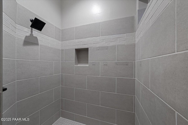 bathroom with a tile shower