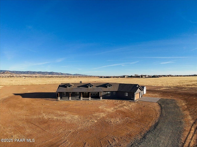 view of front of home featuring a mountain view and a rural view