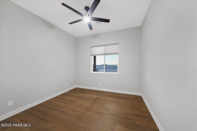 unfurnished room featuring ceiling fan and dark wood-type flooring