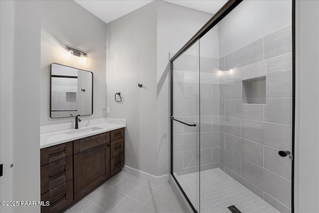 bathroom with tile patterned floors, vanity, and a shower with door