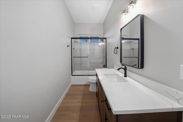 full bathroom with vanity, toilet, shower / bath combination with glass door, and wood-type flooring