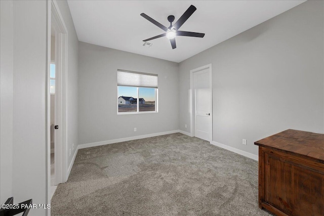 unfurnished bedroom with ceiling fan and light colored carpet