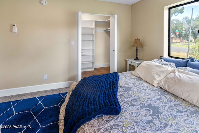 bedroom featuring a spacious closet and a closet