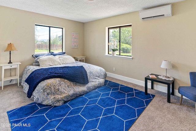 carpeted bedroom featuring a wall mounted AC and a textured ceiling