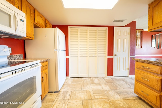 438 Jasmine Ln, Prescott, AZ 86301 - kitchen featuring white appliances, brown cabinetry, and light stone finish floors