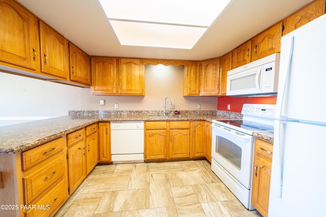 438 Jasmine Ln, Prescott, AZ 86301 - kitchen with white appliances, a sink, brown cabinetry, light stone finish flooring, and light stone countertops