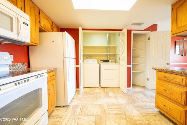438 Jasmine Ln, Prescott, AZ 86301 - kitchen featuring white appliances, washing machine and dryer, brown cabinetry, and light stone countertops