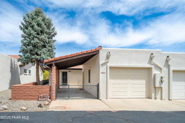 438 Jasmine Ln, Prescott, AZ 86301 - view of front of house featuring driveway, a garage, stucco siding, a gate, and fence
