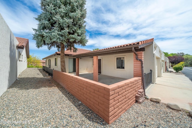 438 Jasmine Ln, Prescott, AZ 86301 - rear view of property featuring stucco siding, a tile roof, a patio, and fence