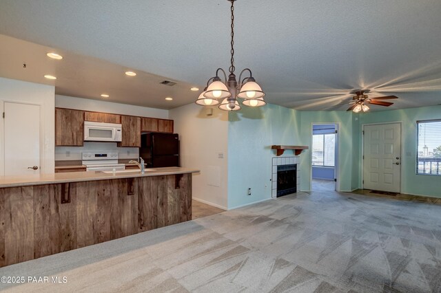 kitchen featuring open floor plan, visible vents, recessed lighting, white appliances, and brown cabinets