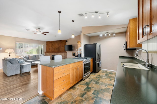 2770 Ridge Rd, Prescott, AZ 86301 - kitchen featuring appliances with stainless steel finishes, a ceiling fan, open floor plan, a peninsula, and decorative light fixtures