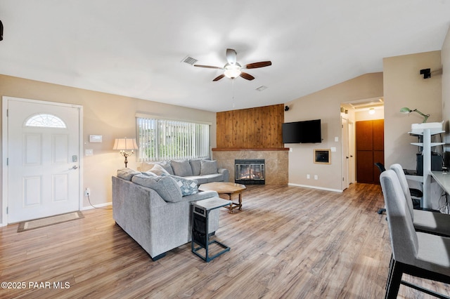 2770 Ridge Rd, Prescott, AZ 86301 - living area with a ceiling fan, light wood-type flooring, vaulted ceiling, and a tiled fireplace
