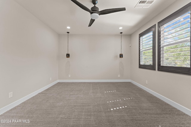 carpeted spare room with ceiling fan