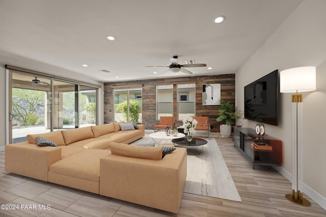 living room with ceiling fan and light wood-type flooring