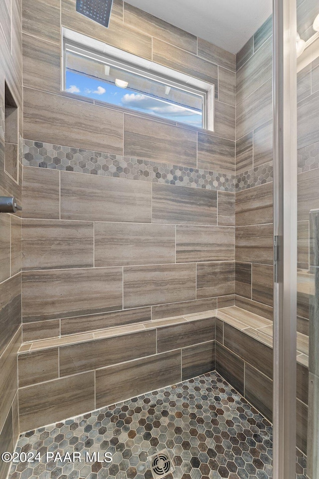 bathroom with a tile shower