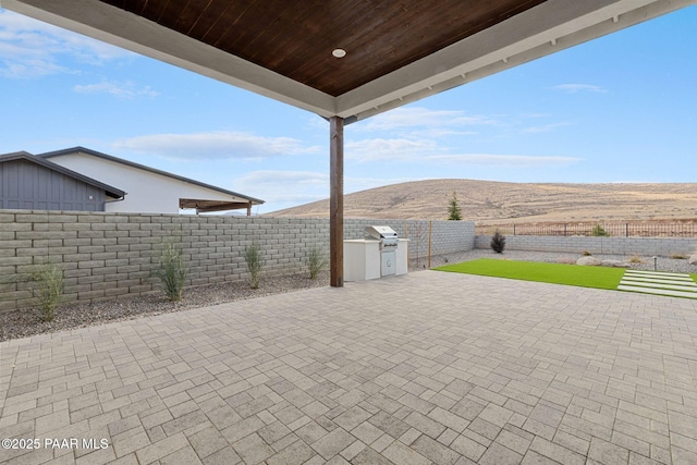 4655 E Alma Ln, Prescott Valley, AZ 86314 - fenced backyard with a mountain view, a patio area, and area for grilling