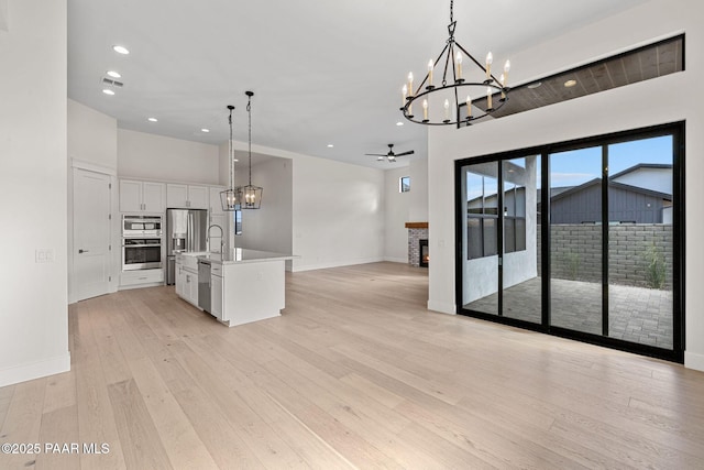 4655 E Alma Ln, Prescott Valley, AZ 86314 - kitchen featuring a chandelier, open floor plan, white cabinetry, light wood-style flooring, and recessed lighting