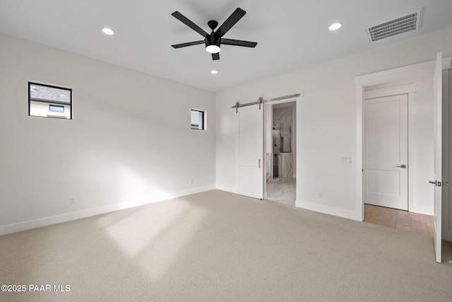 4655 E Alma Ln, Prescott Valley, AZ 86314 - unfurnished bedroom with carpet floors, a barn door, recessed lighting, connected bathroom, and ceiling fan