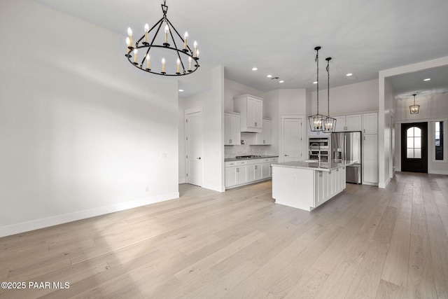 4655 E Alma Ln, Prescott Valley, AZ 86314 - kitchen with a chandelier, stainless steel appliances, white cabinets, light wood finished floors, and recessed lighting