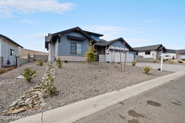 4655 E Alma Ln, Prescott Valley, AZ 86314 - view of front of home with brick siding, an attached garage, concrete driveway, and board and batten siding