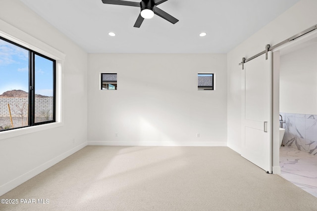 4655 E Alma Ln, Prescott Valley, AZ 86314 - unfurnished bedroom with a barn door, light colored carpet, recessed lighting, and a ceiling fan