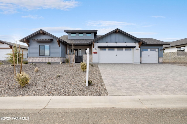 4655 E Alma Ln, Prescott Valley, AZ 86314 - view of front of home with brick siding, an attached garage, driveway, board and batten siding, and roof with shingles
