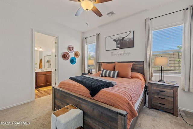 5180 N Elliot Ave, Prescott Valley, AZ 86314 - bedroom with visible vents, light carpet, baseboards, ensuite bathroom, and ceiling fan