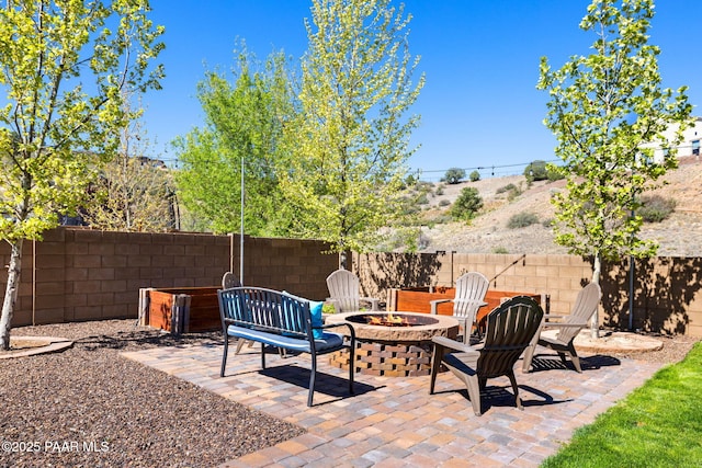view of patio with fence and an outdoor fire pit