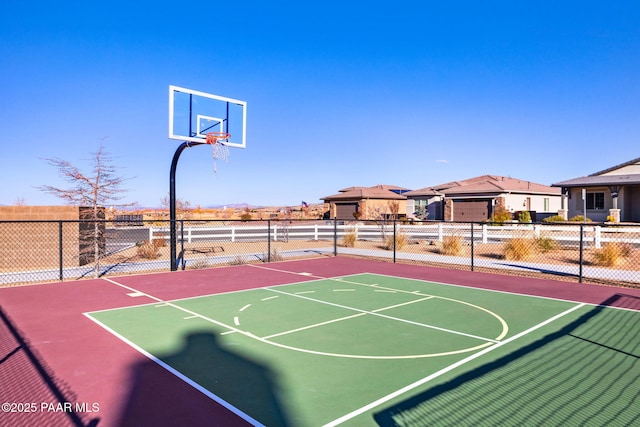 view of basketball court featuring fence and community basketball court