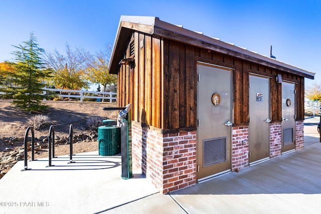 view of outbuilding featuring fence, central air condition unit, and an outbuilding
