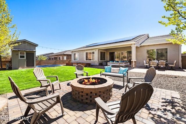 view of patio / terrace with a storage unit, an outdoor structure, a fenced backyard, and outdoor dining space