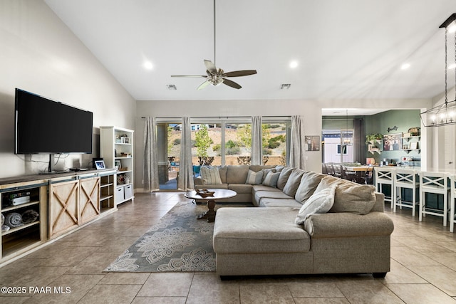 living room with tile patterned flooring, ceiling fan with notable chandelier, recessed lighting, and visible vents