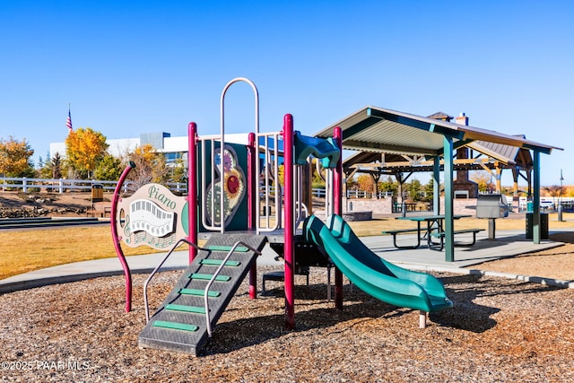 community play area featuring a gazebo and fence