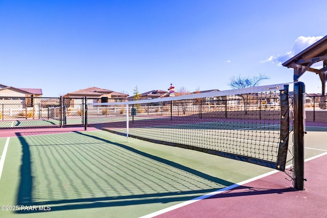 view of tennis court with fence