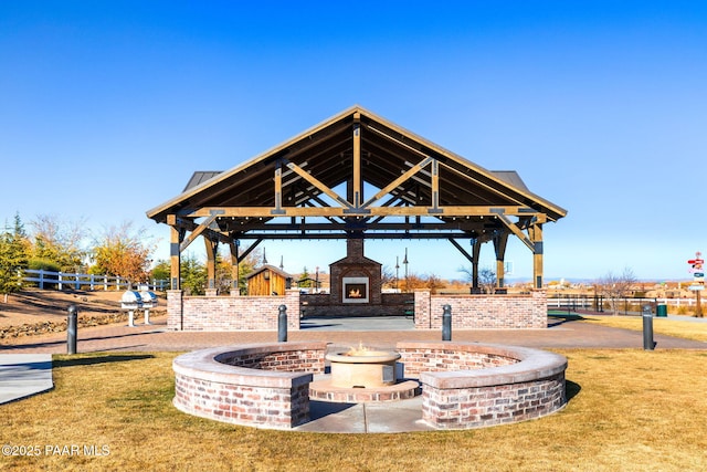 view of community featuring a gazebo, fence, a yard, and a patio