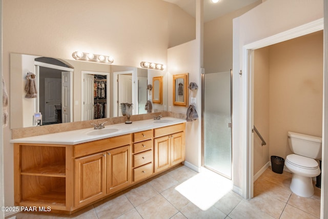 full bathroom with tile patterned flooring, a shower stall, and a sink