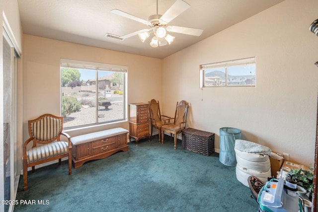 sitting room with visible vents, carpet, a ceiling fan, and vaulted ceiling