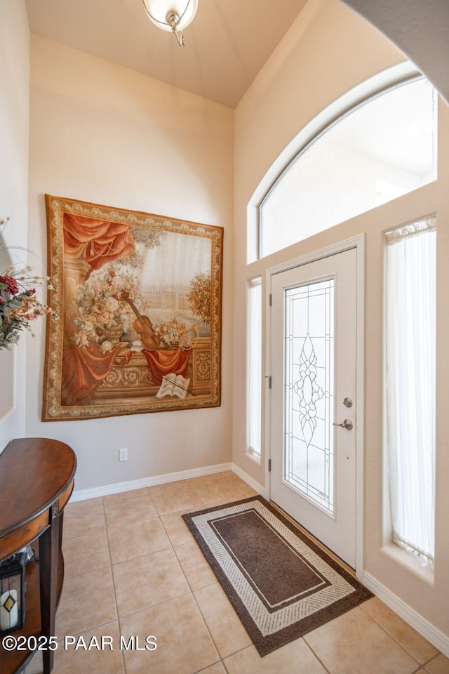 entrance foyer featuring tile patterned floors and baseboards