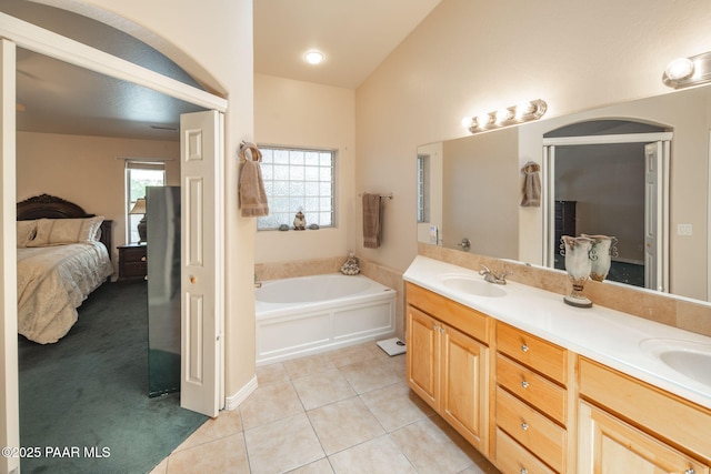 full bath featuring a garden tub, double vanity, a sink, ensuite bathroom, and tile patterned floors