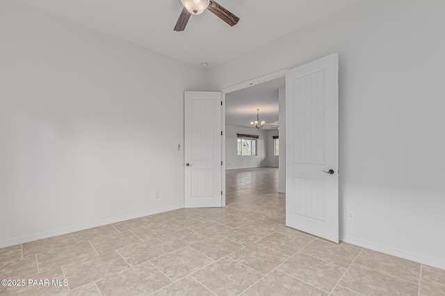 893 Canyon Breeze Ct, Prescott, AZ 86303 - empty room with a chandelier, a ceiling fan, baseboards, and light tile patterned flooring